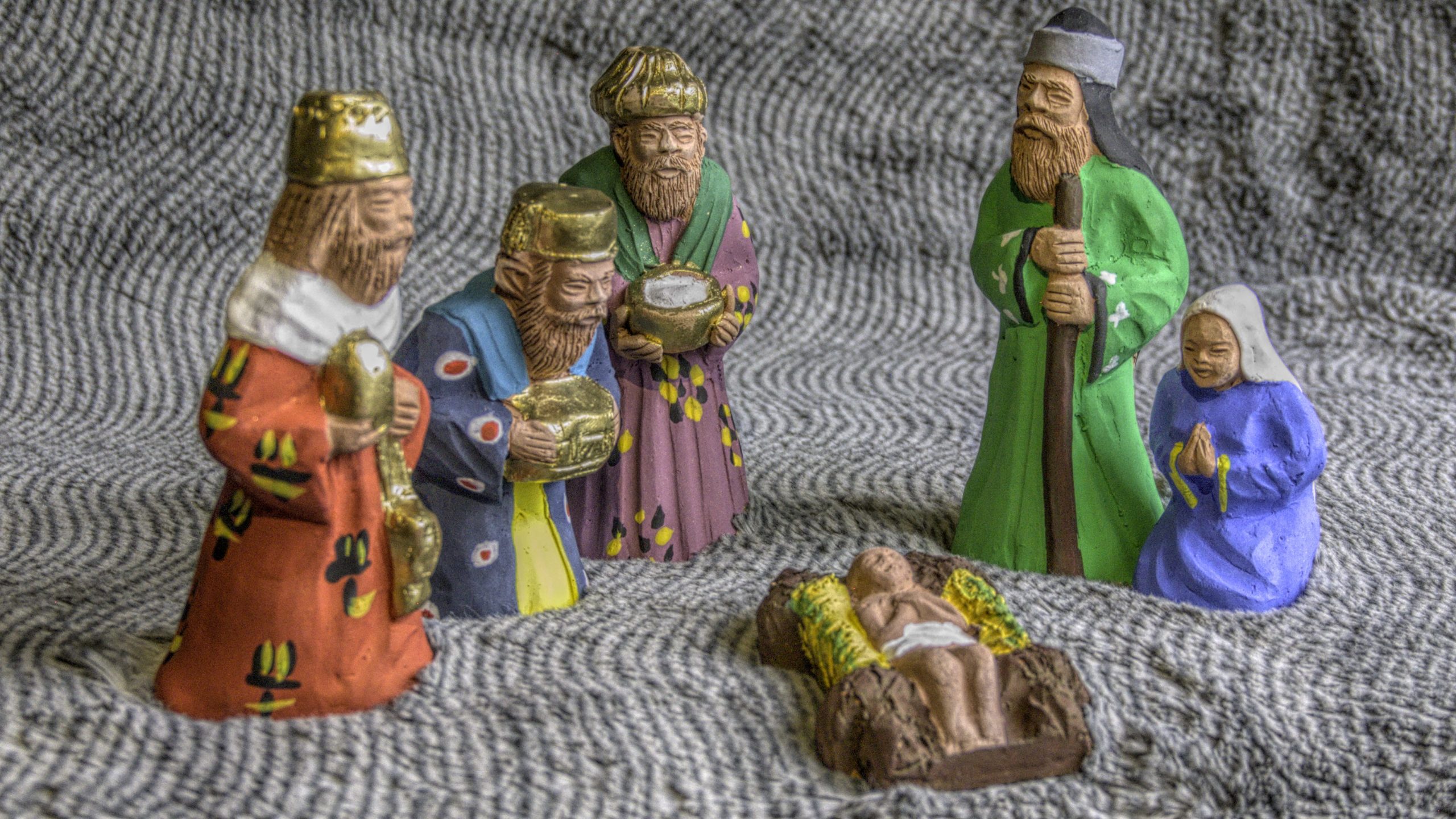 a brightly painted clay nativity set with the holy family and the three Magi created in Egypt