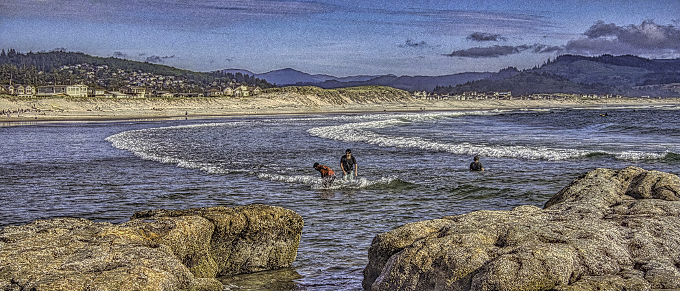 Boys playing in the water at Cape Kiwanda in Oregon