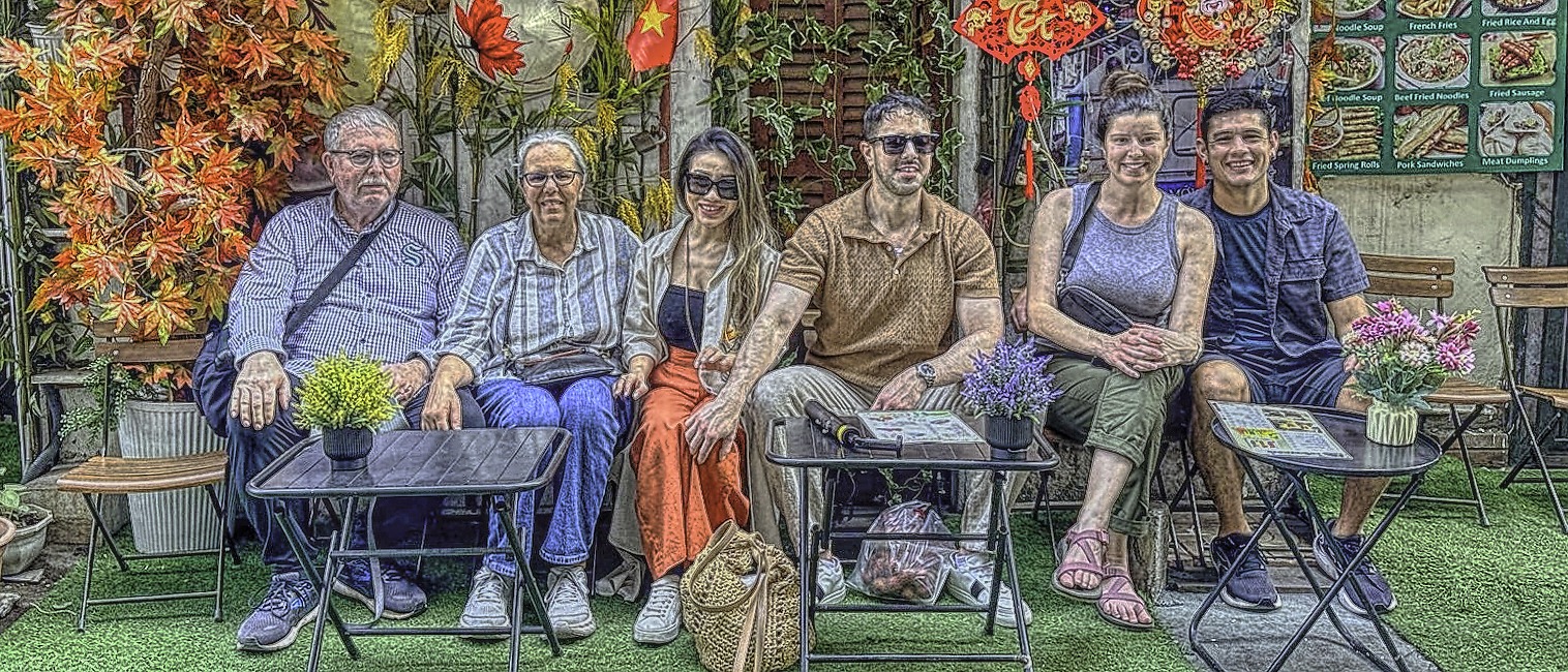 Family ready to watch the train go by in Hanoi, Vietnam