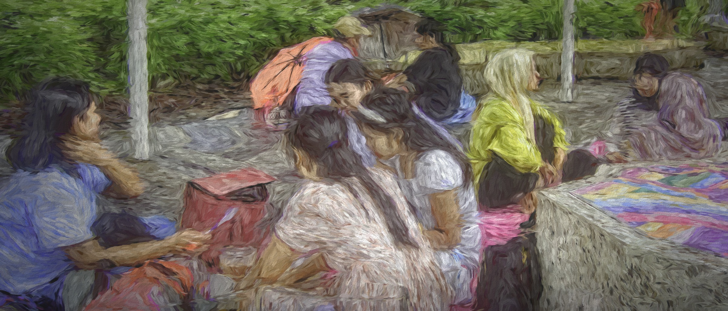 Small groups from Myanmar sit on the ground with friends to celebrate the Myanmar New Year while in Singapore
