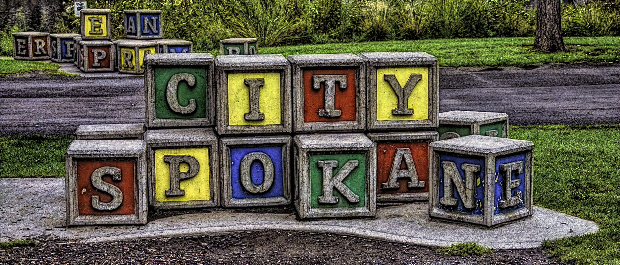 Art installation with large children's letter blocks spelling out City Spokane in Washington state.