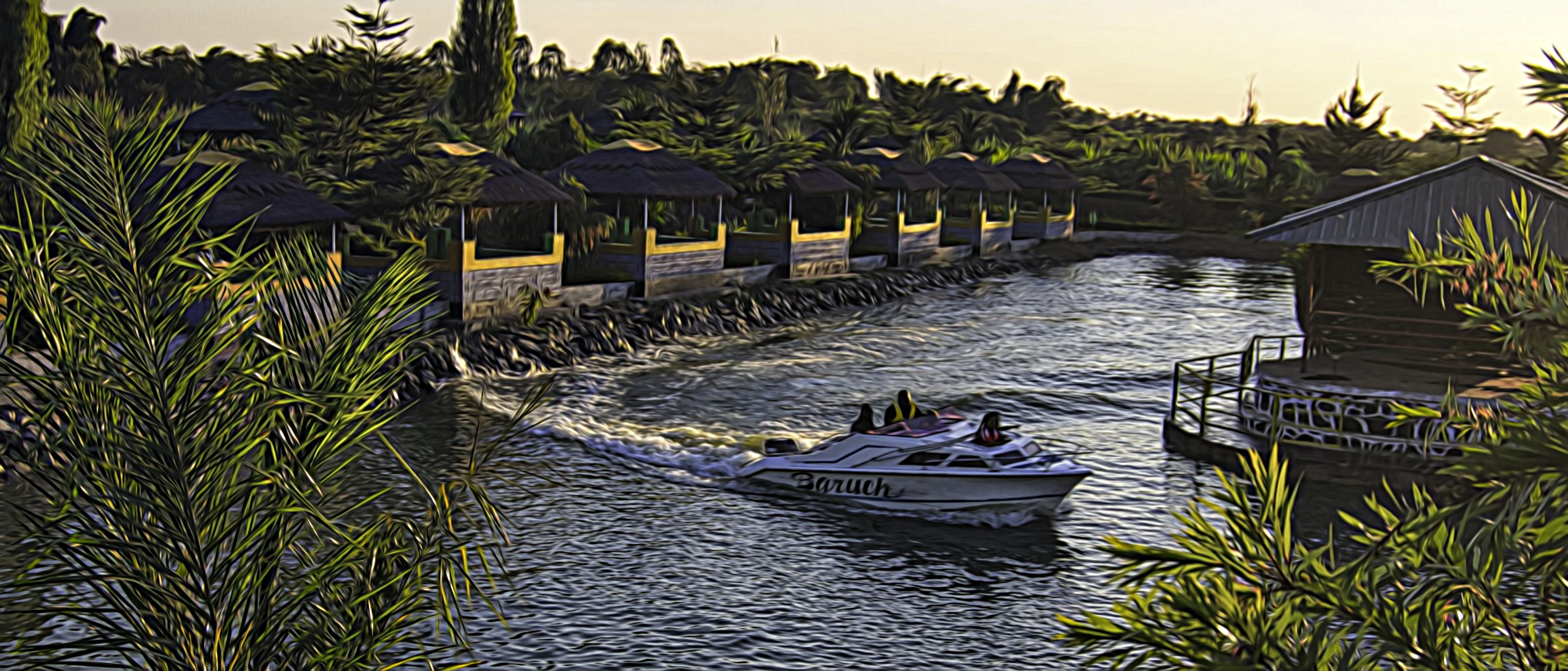 A power boat zips around a small lake in a resort in Lilongwe, Malawi